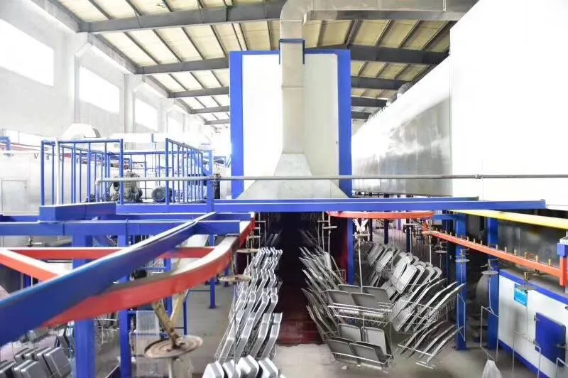 In China bakeware factory, nonstick coating production line, baking pans are hanging on the lines