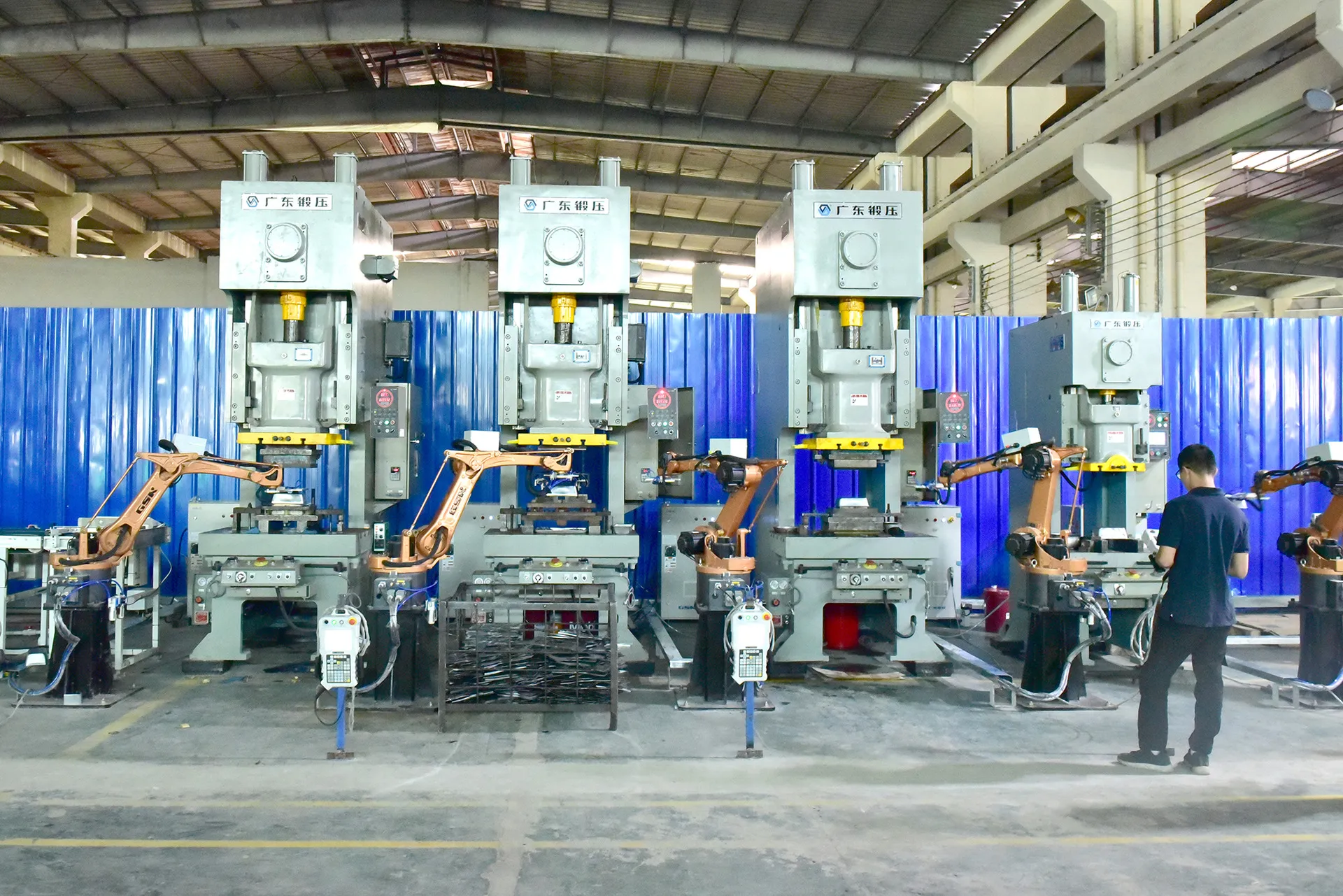 In China bakeware factory, robot automatic hands are doing punching process during bakeware production