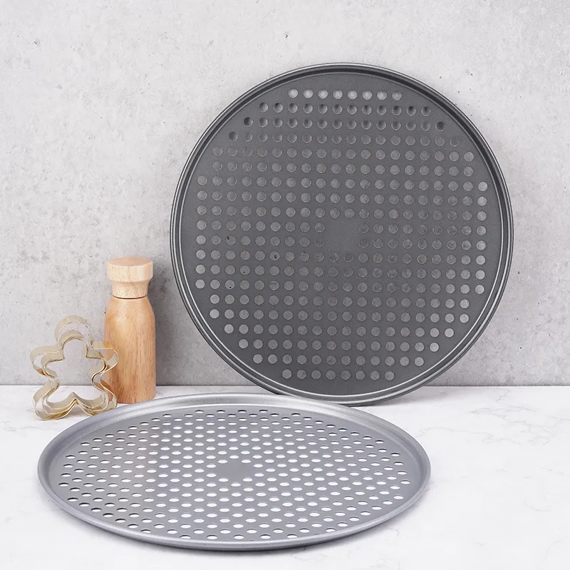 two 14.5-inch Nonstick Perforated Pizza Trays and a Christmas tree shape cookie mold beside